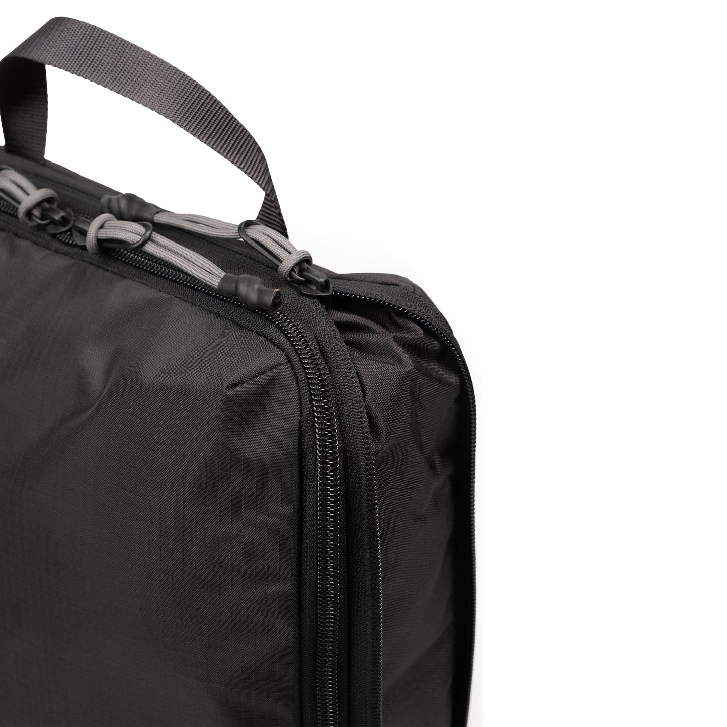 Zipper detail white background image of Topo Designs Global Compression Pack Bag Set in "Black / Black"