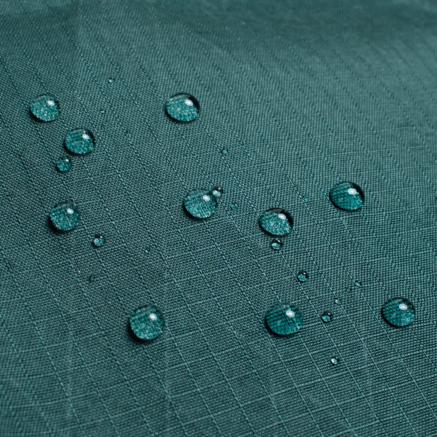 General shot of Topo Designs Global Pro Tech Case water droplets on waterproof material