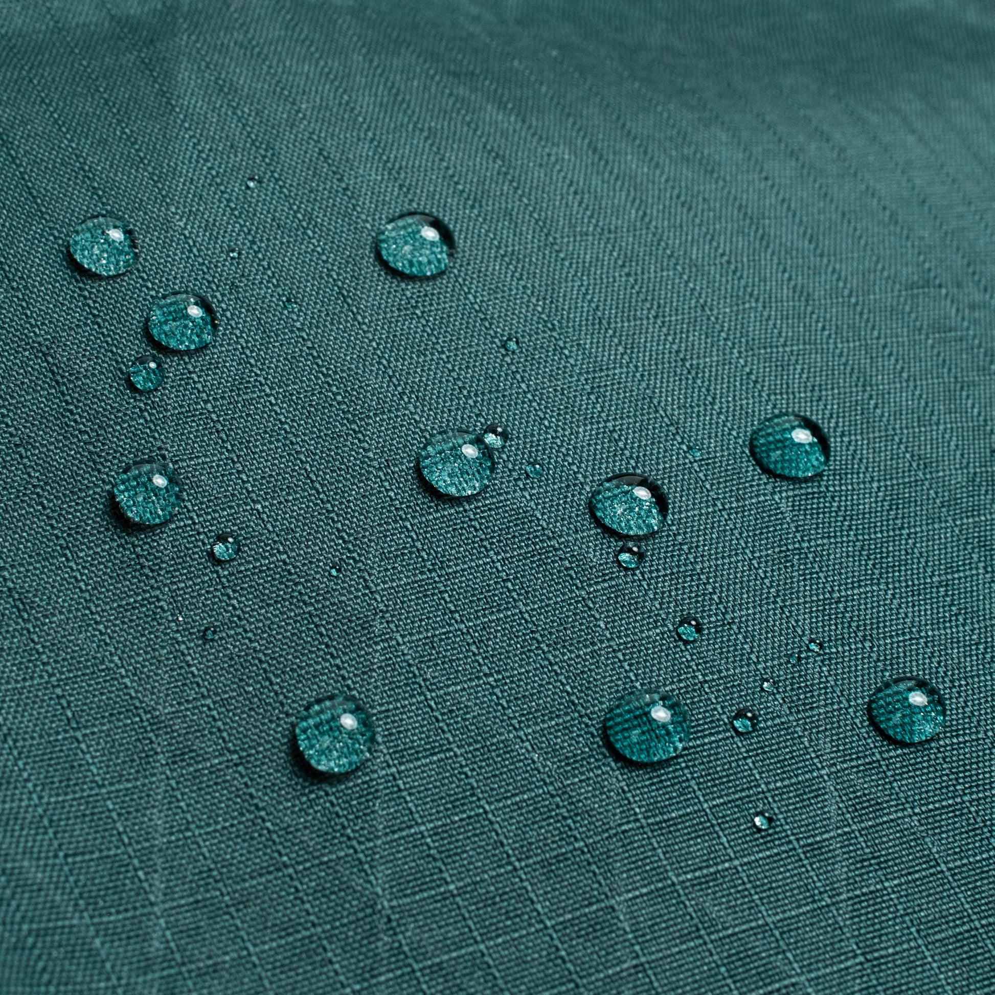 General shot of Topo Designs Global Pro Tech Case water droplets on waterproof material